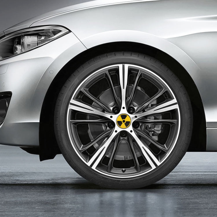 Wheel center cap sticker, yellow and black radiation symbol on car wheel