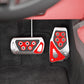 Car foot brake pedal covers with red inserts and silver plates on textured interior