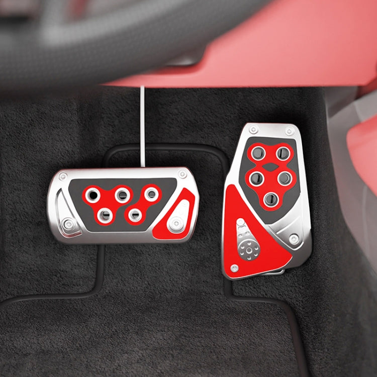 Car foot brake pedal covers with red inserts and silver plates on textured interior