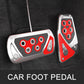 Car foot pedal covers with red and black inserts and silver plates on vehicle floor