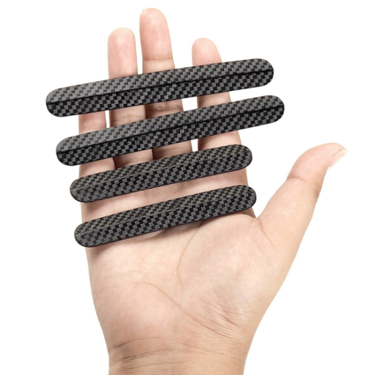 Four carbon fiber patterned anti-collision strips held in hand