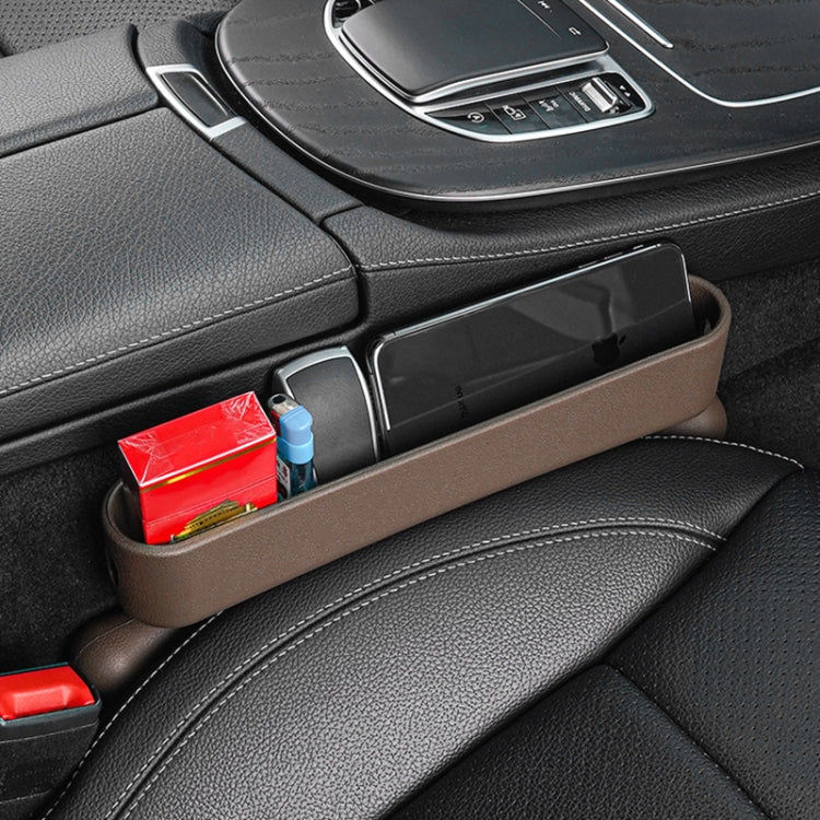 Car seat gap storage organizer, brown tray holding small items beside console