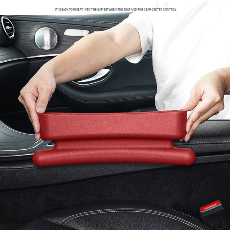 Red car seat crevice storage box being fitted into the seat gap between console parts