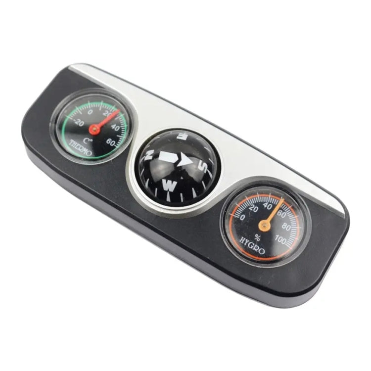 Three-in-one car dashboard compass with direction ball, thermometer, and hygrometer dials.