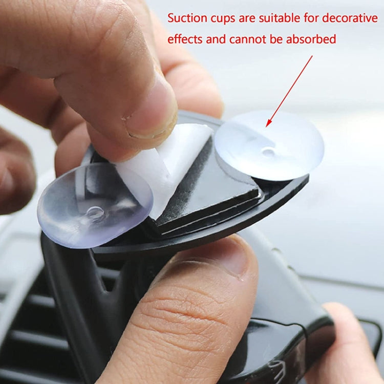 Suction cup mounting for a black car compass ornament pressed onto dashboard
