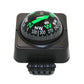 Black dashboard compass ball decoration showing green NW/E/S/W arrows on dial