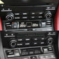 Two black audio knob covers with silver trim rings installed on dashboard