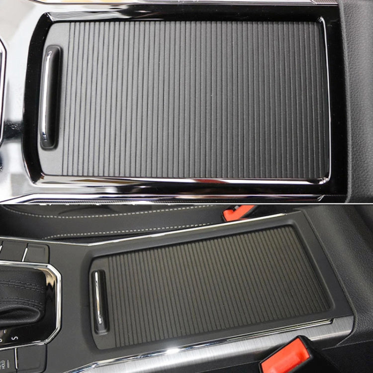 Black ribbed cup holder cover insert installed in dashboard console area