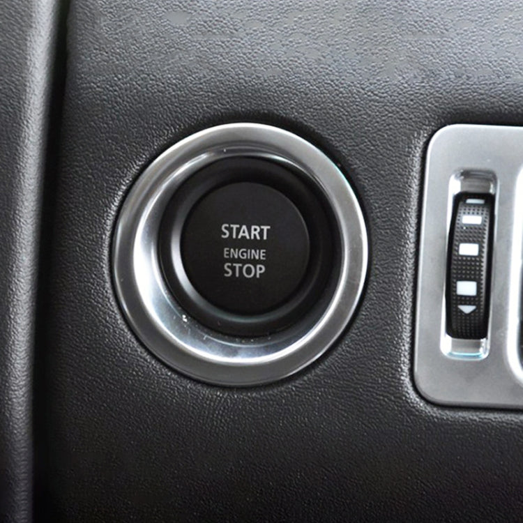 Start/stop engine button installed in dashboard with silver bezel and black center pad