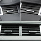 Silver air vent adjustment strip centered on dashboard vent grille.