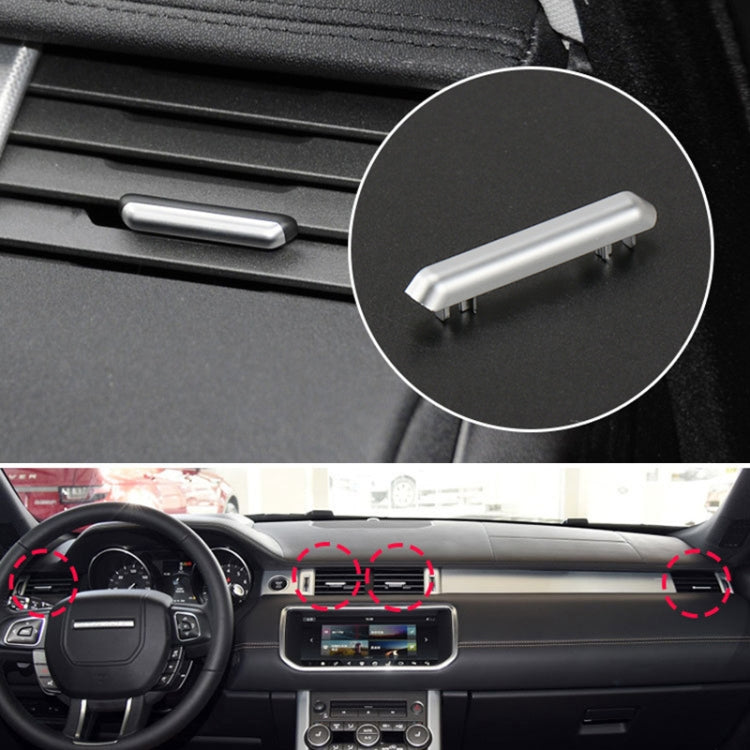 Silver air vent adjustment strip on dashboard vent grille, close-up view.