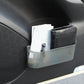 Gray dashboard storage box holding a phone and papers in the console pocket