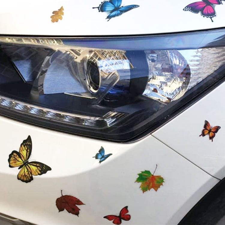 3D butterfly and leaf self-adhesive stickers on a car hood near the headlight