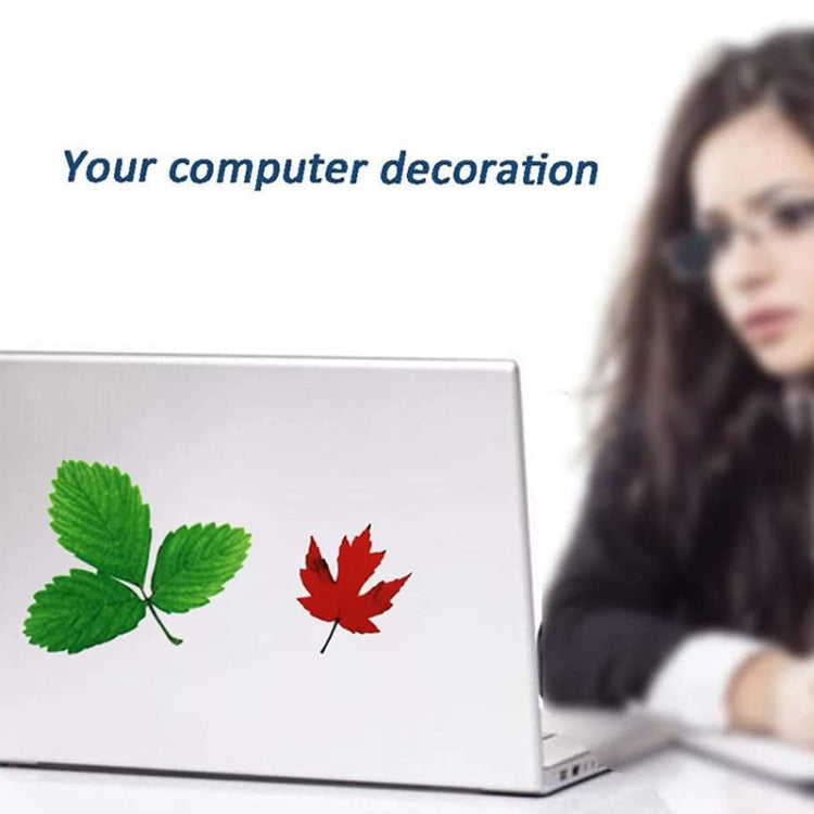 3D leaf stickers on a laptop screen with a pair of leaves in green and red
