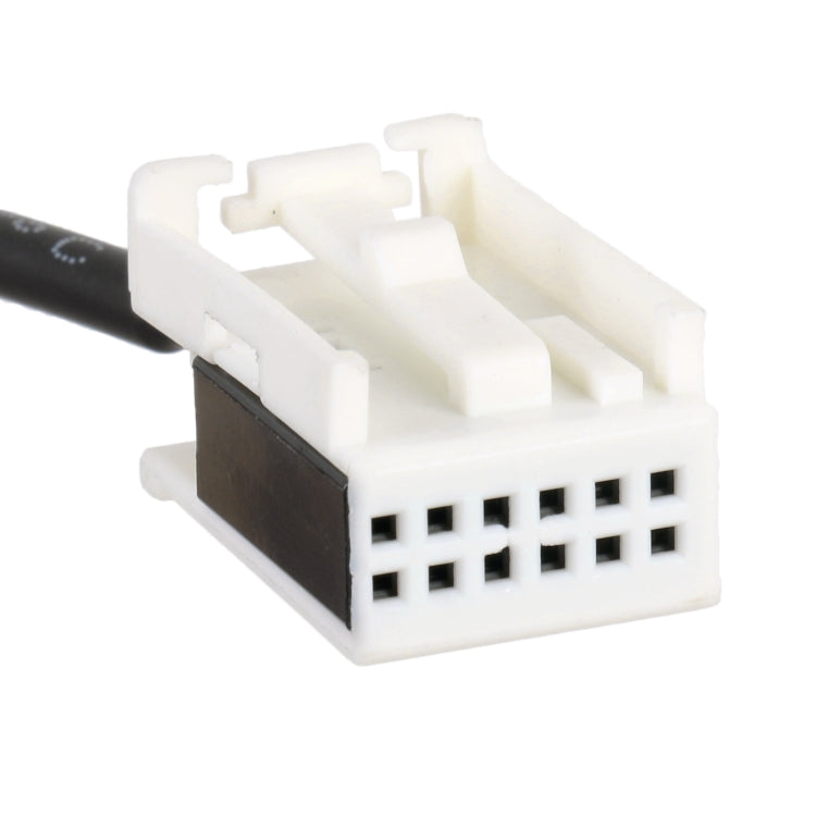 White multipin car audio connector with black insert on AUX input cable