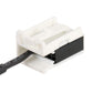 White car audio connector housing with black insert and ribbon pins on cable