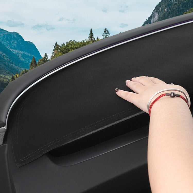 Black dashboard lightproof mat on car dash, hand pressing surface