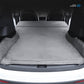 Gray suede car mattress fully spread in vehicle cargo area
