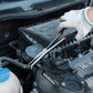 Hose grip pliers used in an engine bay, pointed jaws, black handles, red grip bands