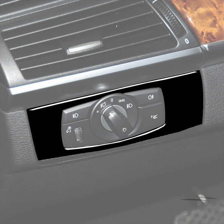 Installed headlight control switch trim sticker with glossy black surround and rotary knob