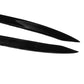 Close-up of two black curved headlight eyebrow sticker strips with glossy finish.