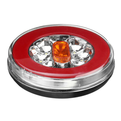 Red oval LED truck taillight with amber center lens and chrome bezel.