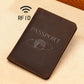Coffee brown RFID leather passport holder with embossed PASSPORT and globe emblem.