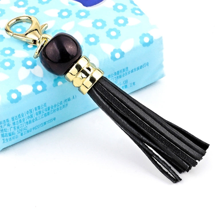 Gold-tone tassel keychain with black bead and black leather tassel strands