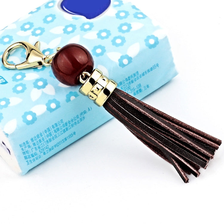 Gold-tone tassel keychain with dark red bead and dark brown leather tassel strands