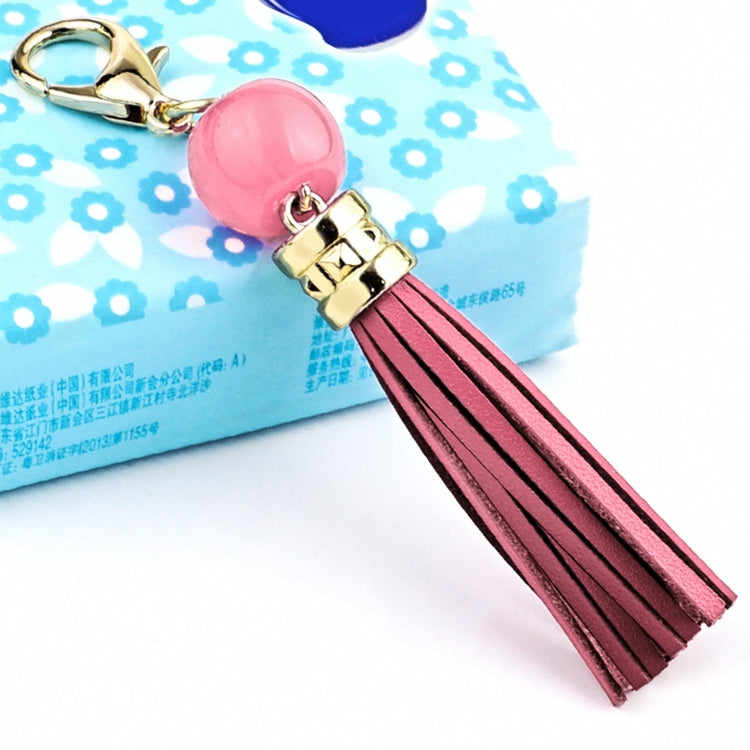 Gold-tone tassel keychain with pink bead and pink leather tassel strands