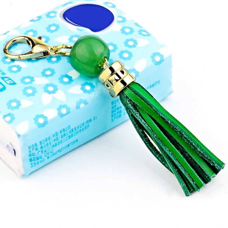 Gold-tone tassel keychain with green bead and green leather tassel strands