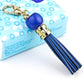 Blue cowhide tassel keychain with round bead and gold carabiner clip