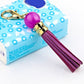 Purple cowhide tassel keychain with round bead and gold carabiner clip