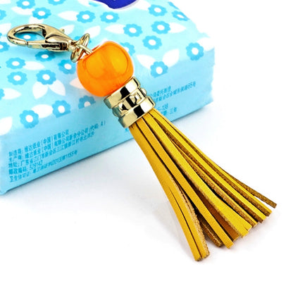 Gold-tone tassel keychain with orange bead and tassel, clip ring clasp