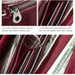Wine red leather wallet close-up with metal zipper and card slots inside