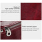 Wine red leather wallet close-up with smooth metal zipper and stitched detailing