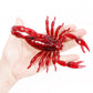 Red translucent scorpion toy held in an open palm