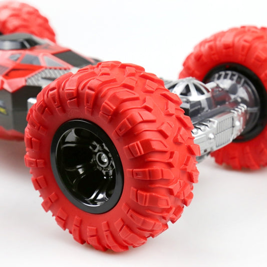 Red RC truck close-up of front tire tread, wheel rim, and visible undercarriage