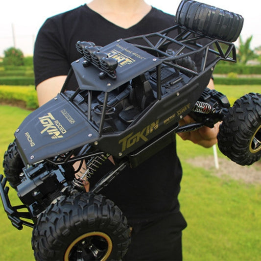 Black remote control off-road climbing car with large tread tires and front bumper detail