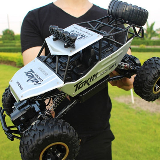 Silver remote control off-road climbing car with large tread tires and front bumper detail