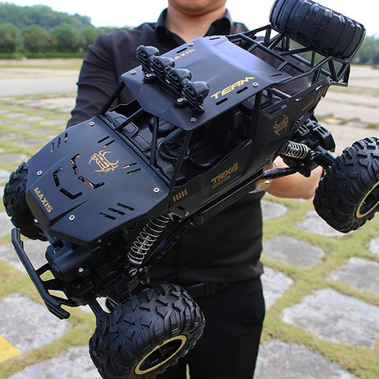 Black off-road remote control climbing car with roll cage and large knobby tires
