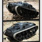Grey and black RC tank model climbing over rocks, side view