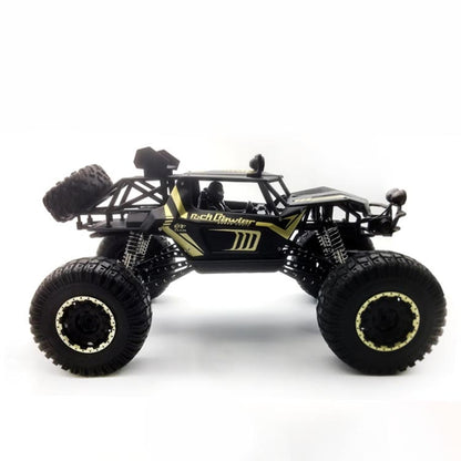 Black and gold RC off-road climbing truck toy with oversized knobby tires and roll cage
