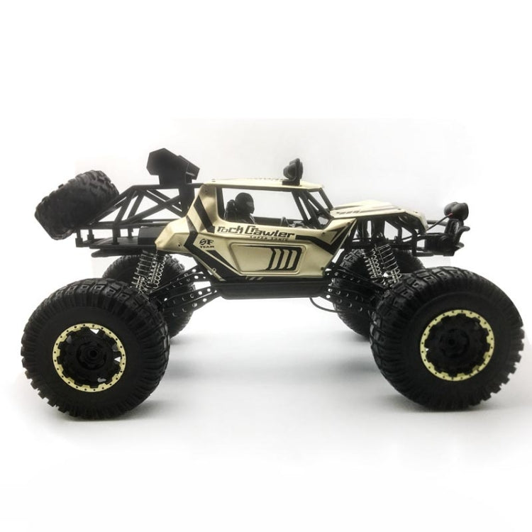 Black and gold RC off-road climbing truck toy with four large tires and front lights