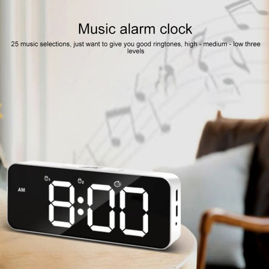 Black LED alarm clock on tabletop with large segmented time digits