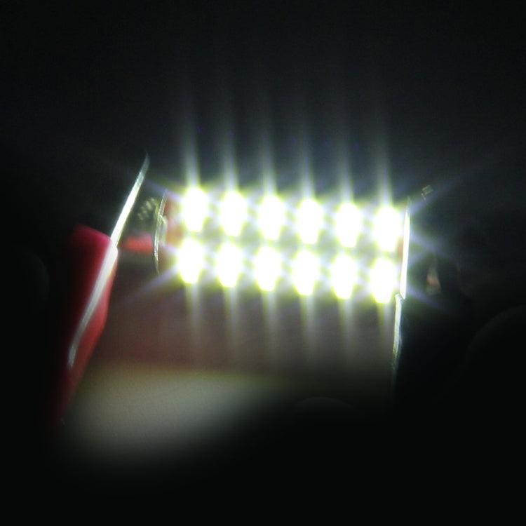 LED festoon dome light emitting bright white glow, metal end caps visible
