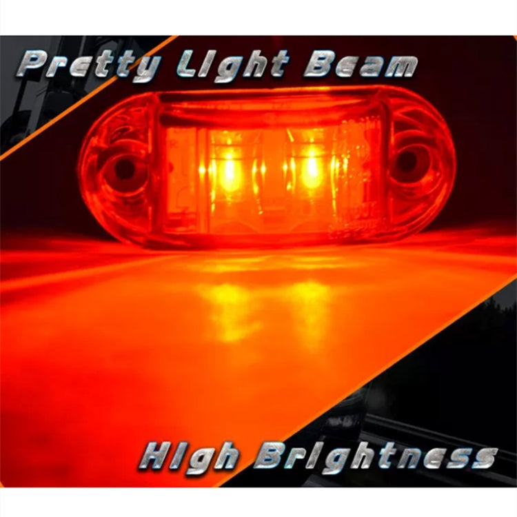 Red oval LED side marker light showing bright amber-red LED glow, clear lens, two holes.