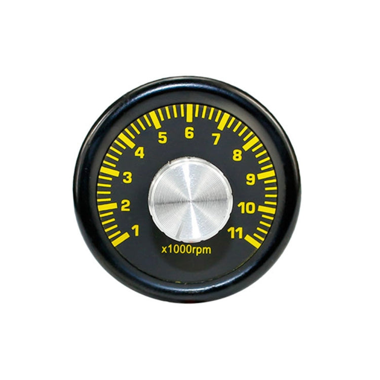 Yellow RPM tachometer gauge face with black bezel and silver center knob