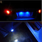 White LED license plate bulbs glowing on a vehicle at night with bright downlight