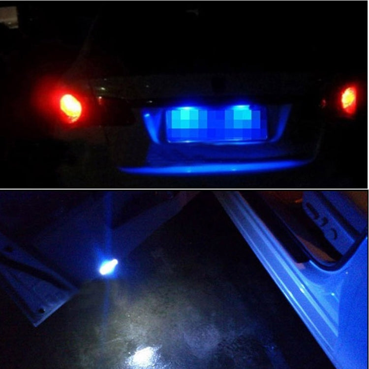White LED license plate bulbs glowing on a vehicle at night with bright downlight